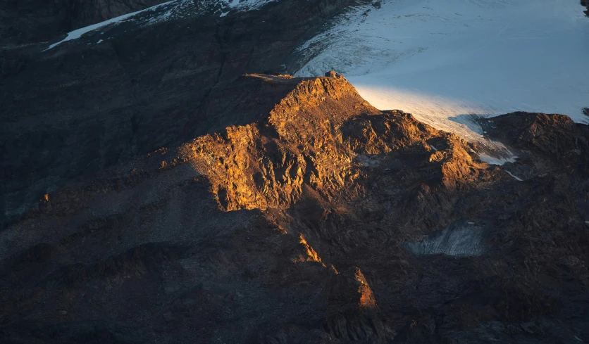 the sun shining on a snow covered mountain