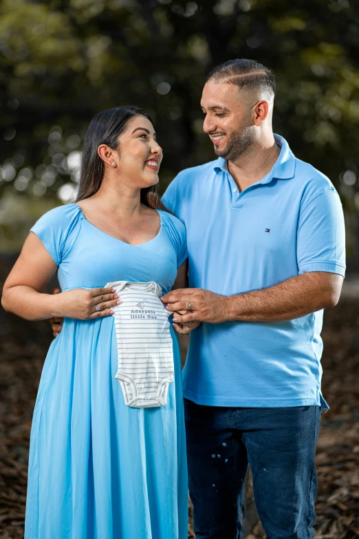 a man and woman smile while standing together