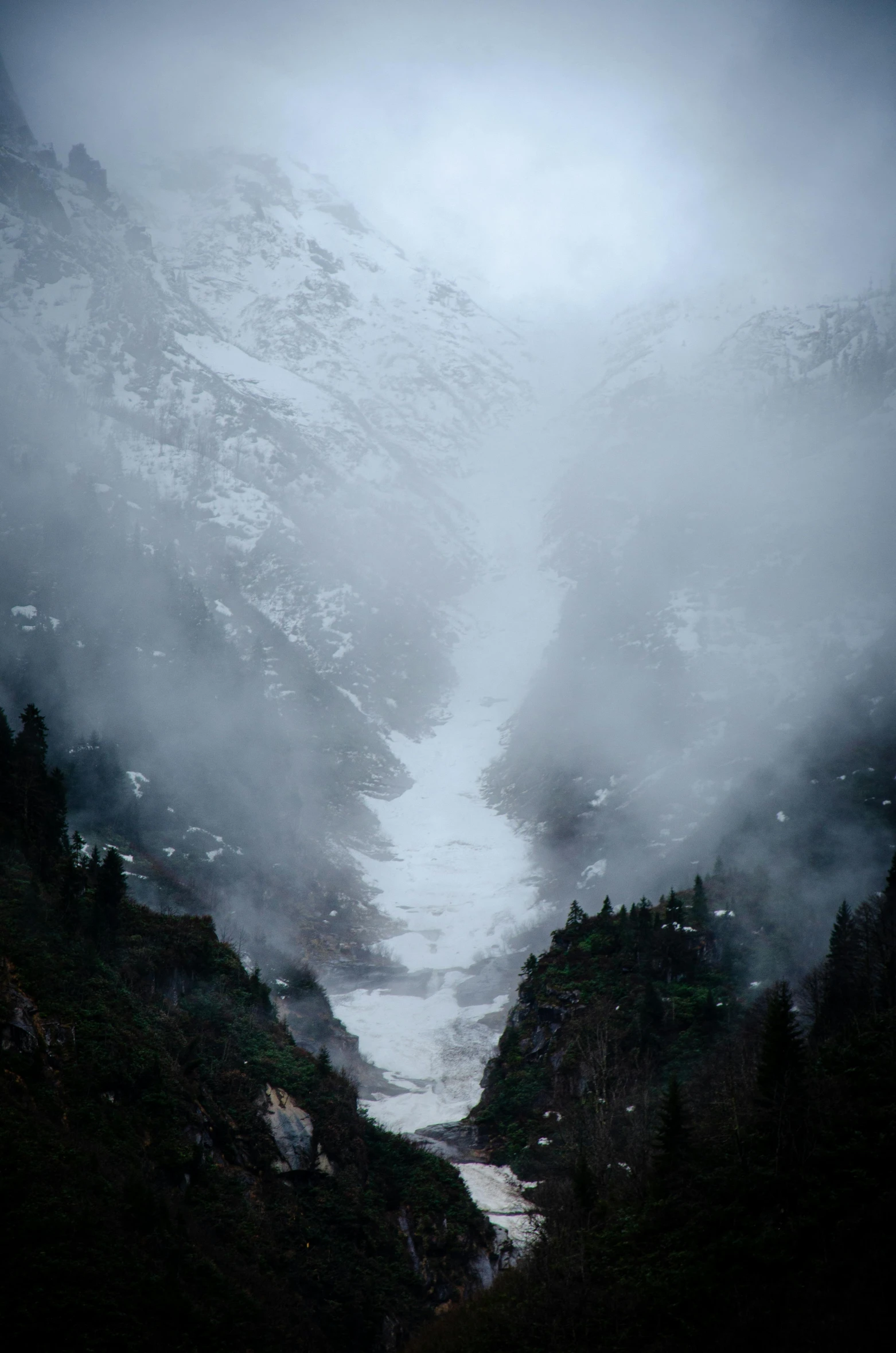 a snowy river with mountains in the background