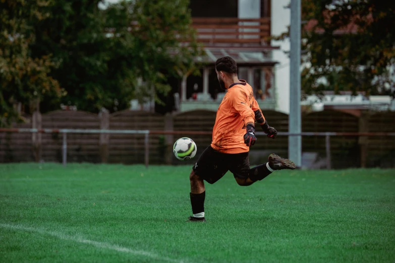 a soccer player is running with the ball