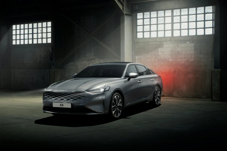 a gray car parked inside a building near windows