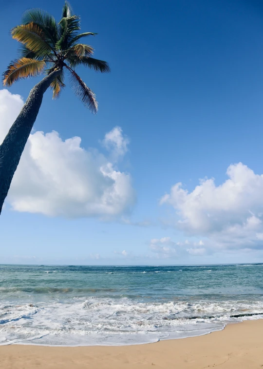 an empty beach and blue sky with clouds