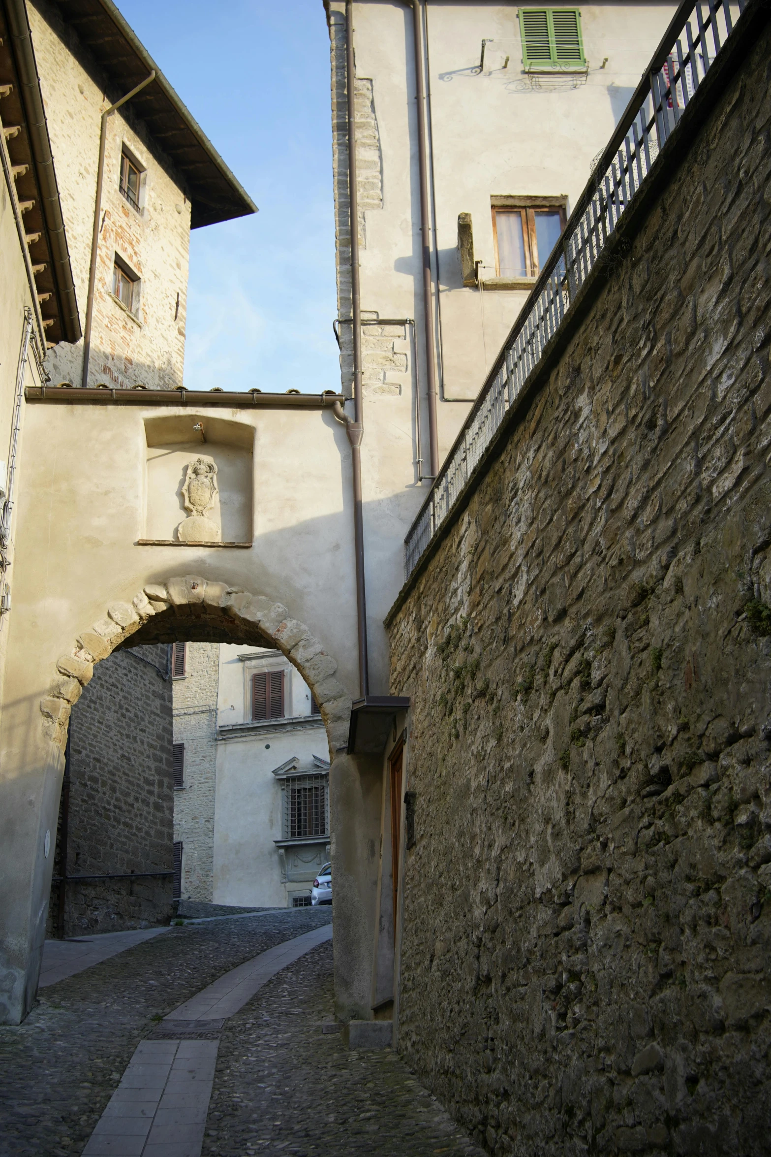 an archway between two buildings with a clock