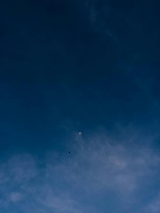 a jetliner flies through the sky with clouds above