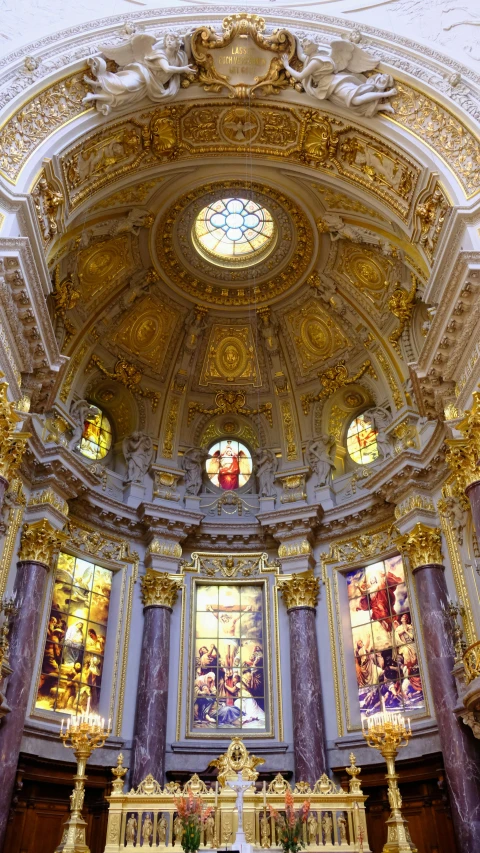 the inside of an ornate cathedral with large, intricate ceilings and stained glass