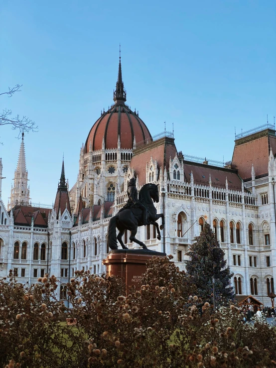 a statue in front of a large building