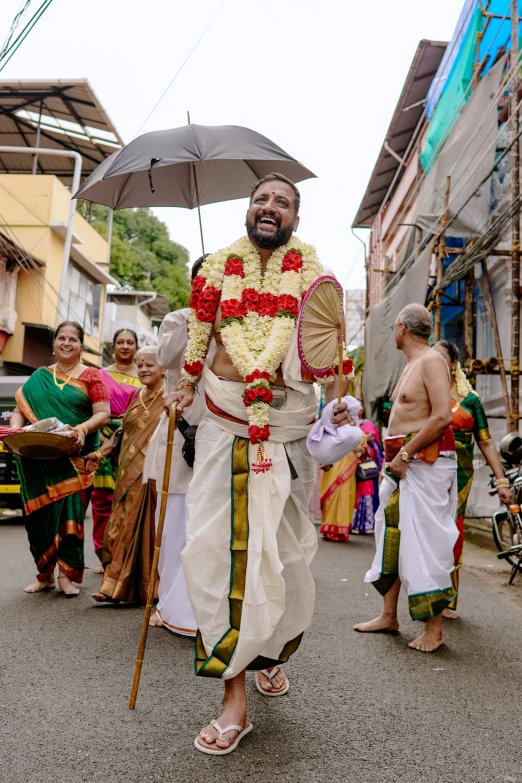 a man with an umbrella walking in a parade