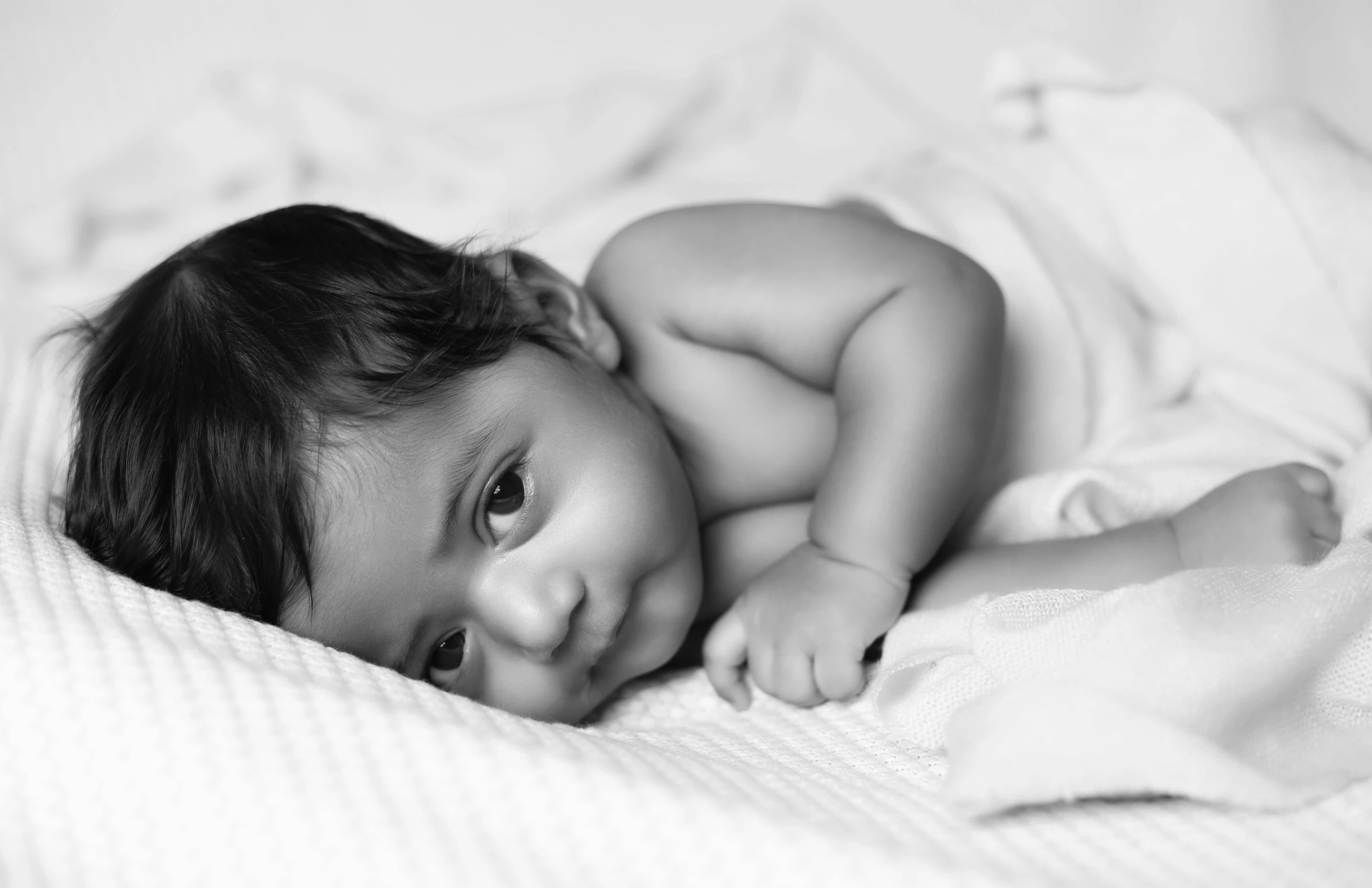 a small child laying on top of a bed