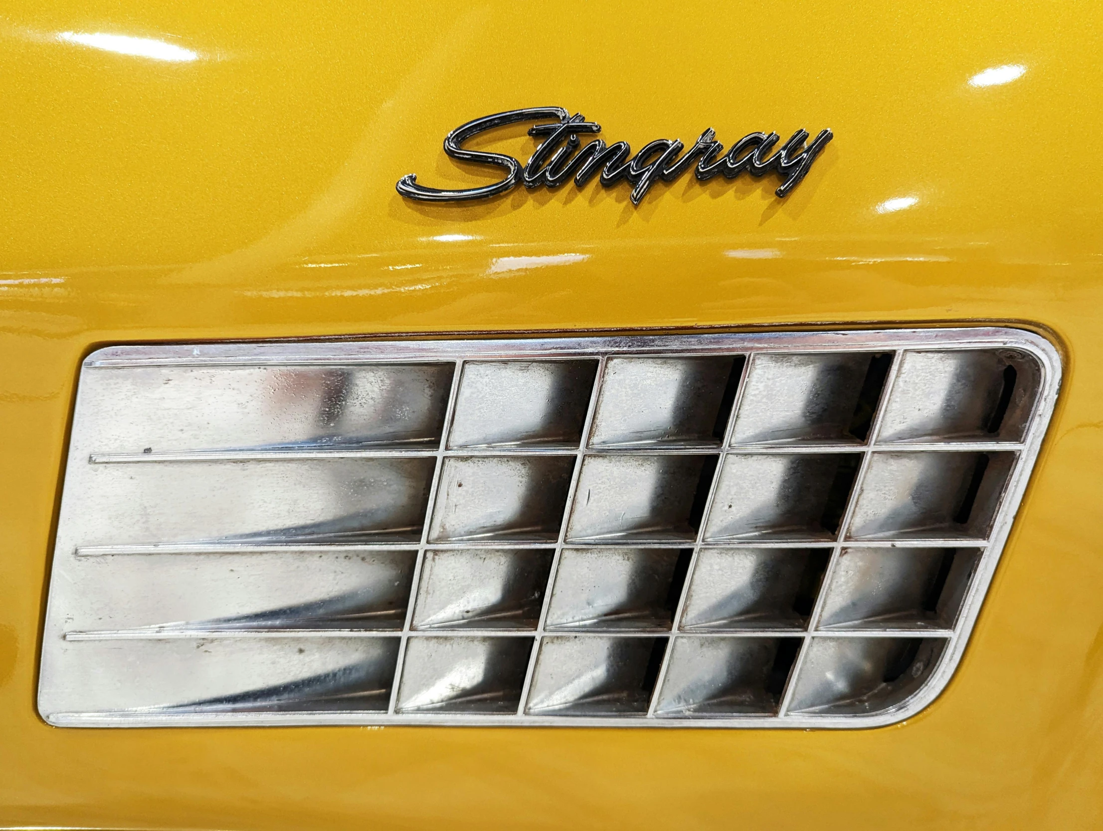 the front end of a yellow pickup truck