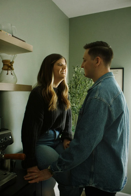 the man and woman are in the kitchen together