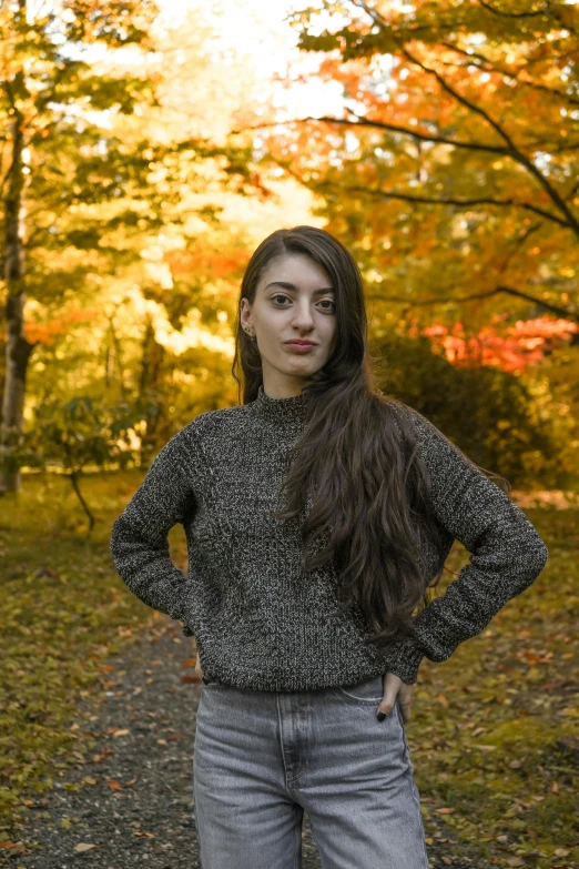 the woman stands on a path in the forest