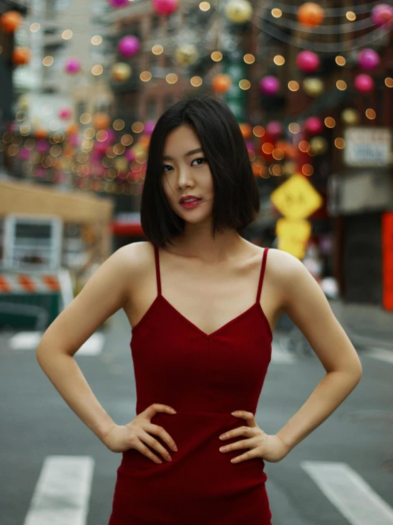 a woman in red is standing on the street