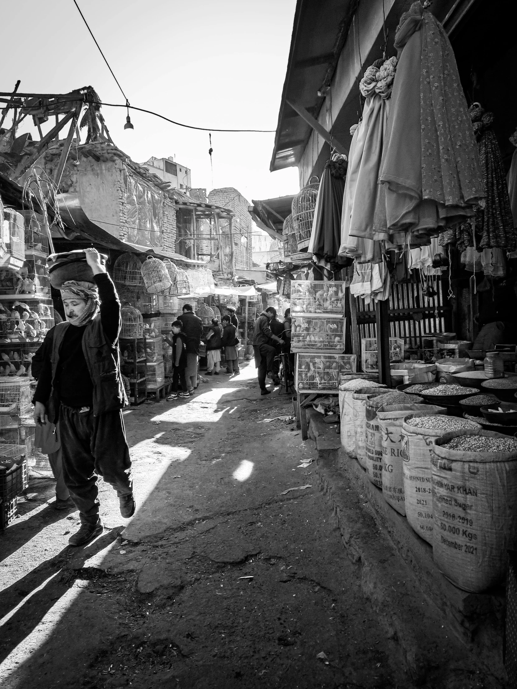 a black and white po of people in a market