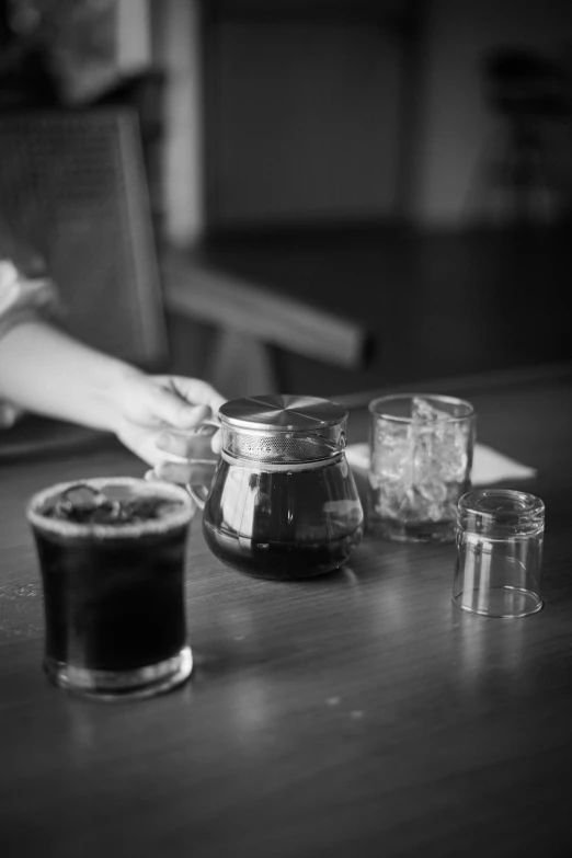 several s glasses and a glass with liquid are on the table