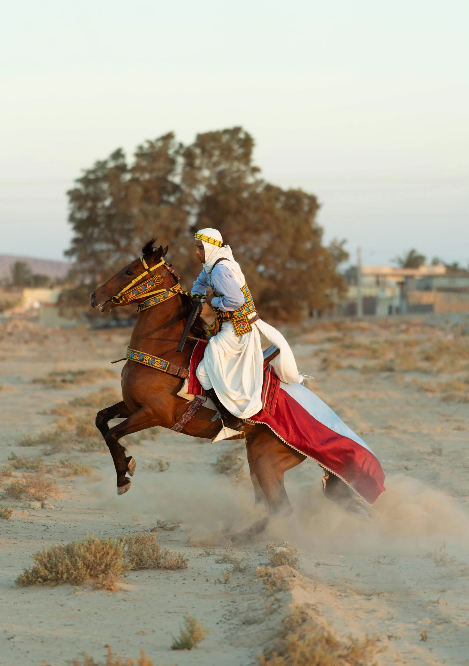 a man riding on the back of a brown horse