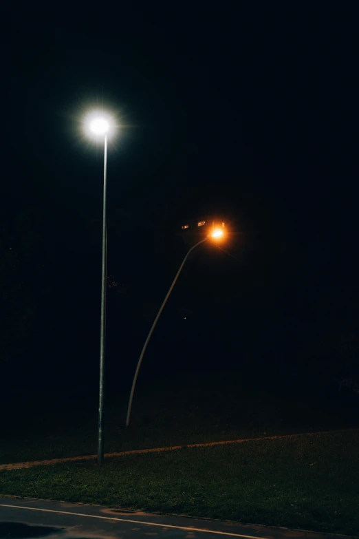 an empty park with some street lights lit up