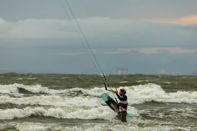 a man is riding waves on a kite board