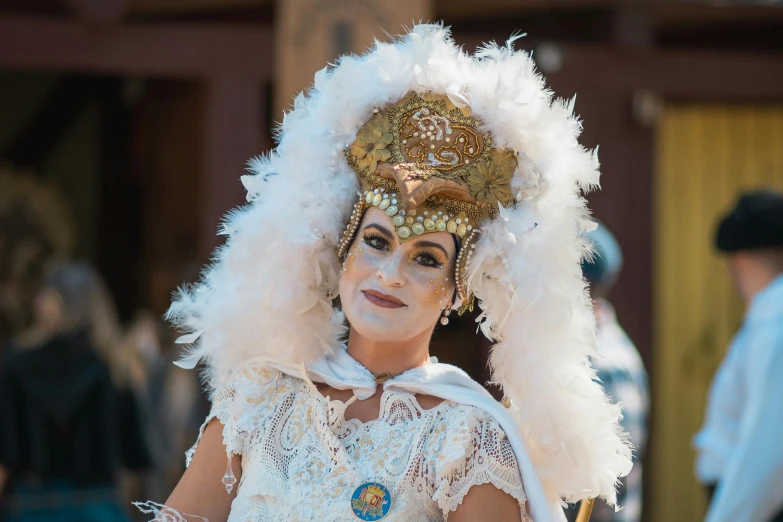 a close up of a woman wearing a white head dress