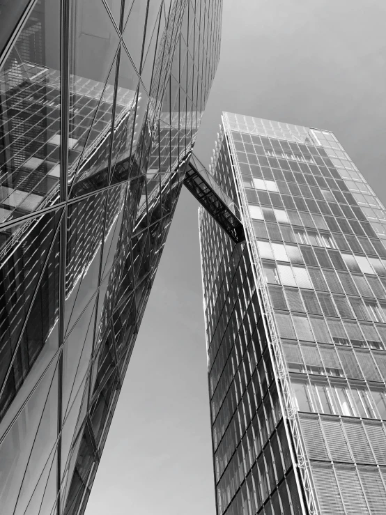 looking up at a tall skyscr against a cloudy sky