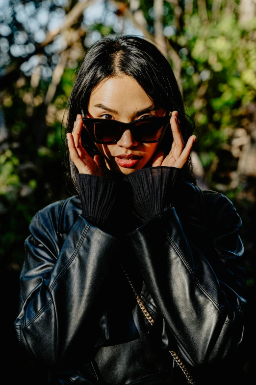 a woman with dark hair wearing black sunglasses