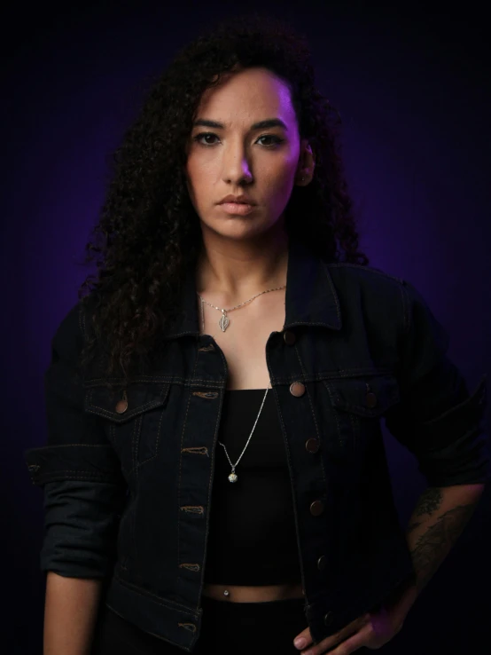 a young woman wearing black clothing posing for the camera