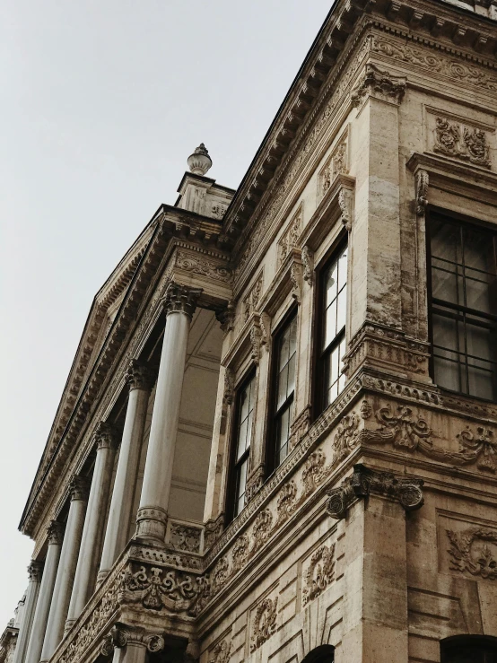 an old building is standing upright on a gray day