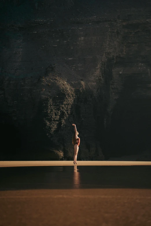 a woman standing in front of a black mountain