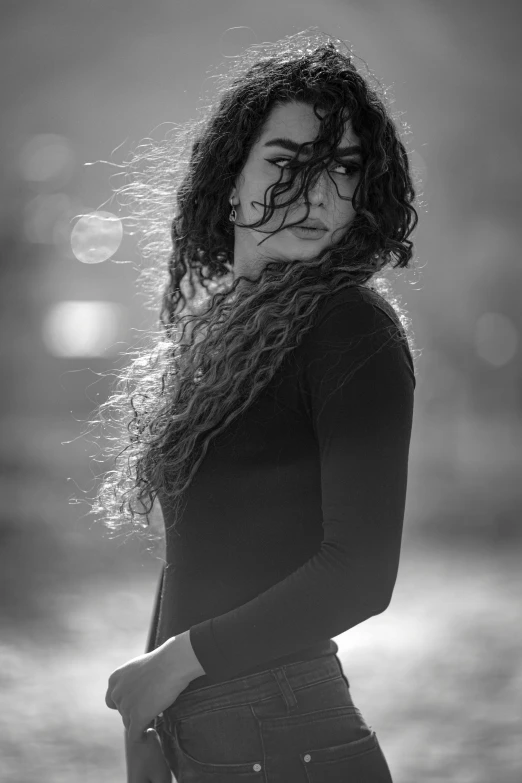 a woman standing in a body of water wearing black