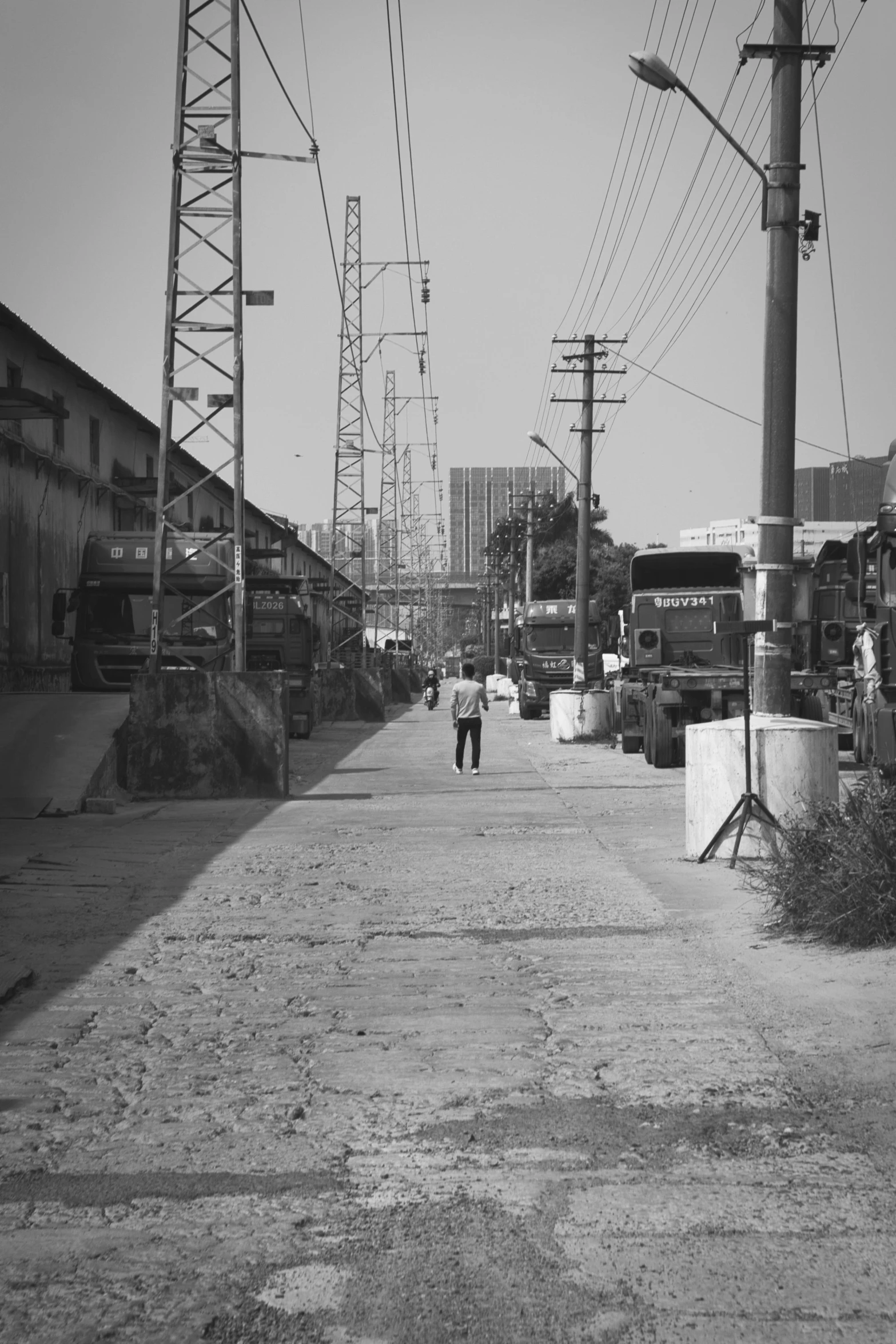 there is a man walking through an area with power lines