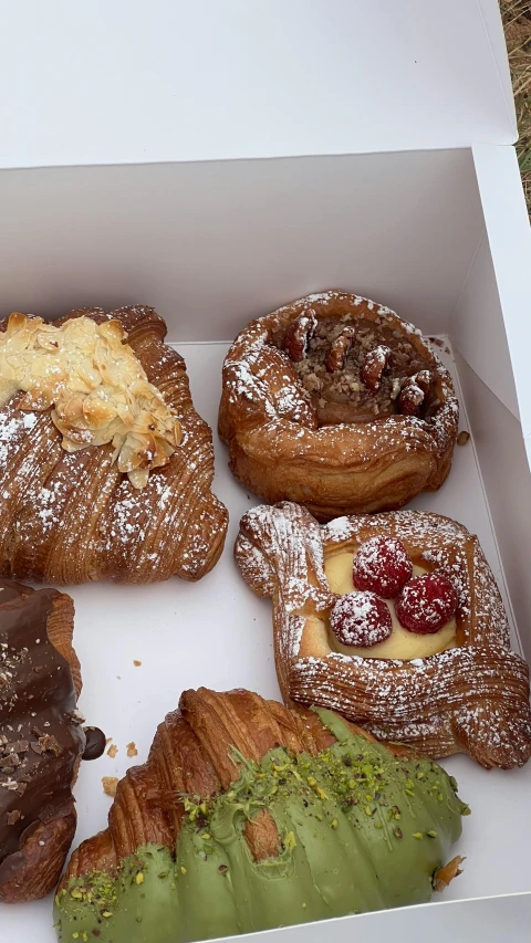a white box filled with different flavored pastries
