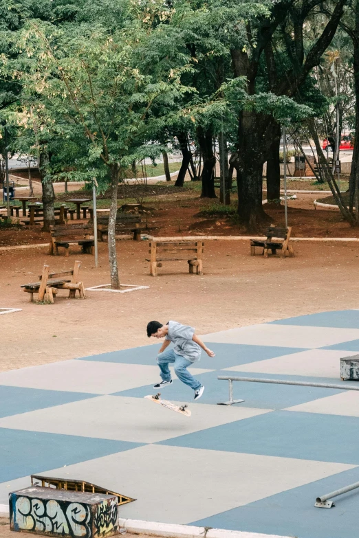 a boy doing skateboard tricks in a park