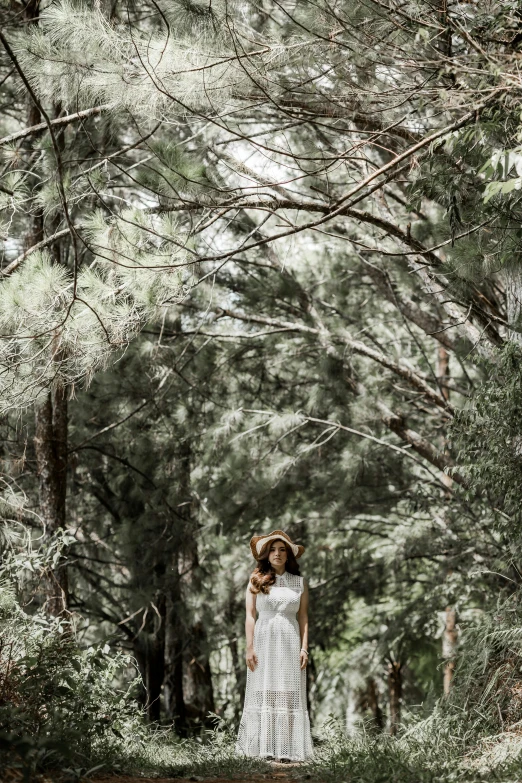 a woman in a dress walks on the dirt path