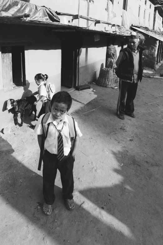  in shirt and tie standing on the side walk