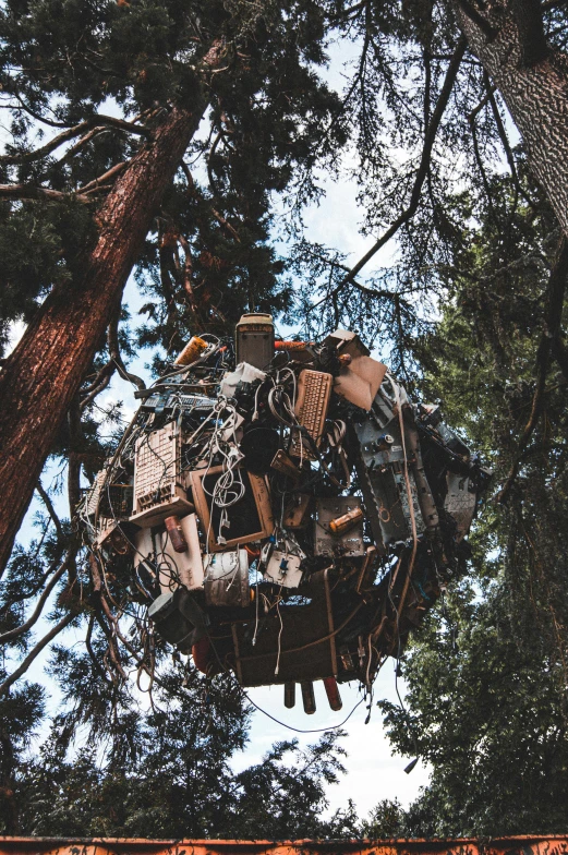 an upside down statue in the middle of a forest