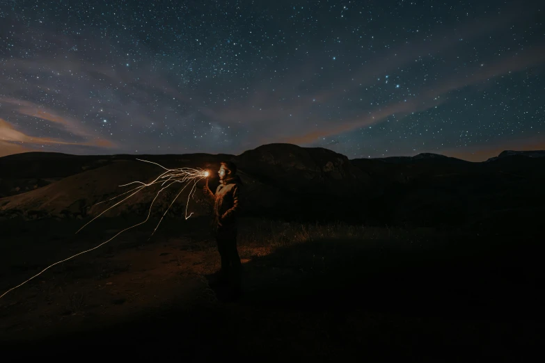 woman standing in front of a dark sky with stars