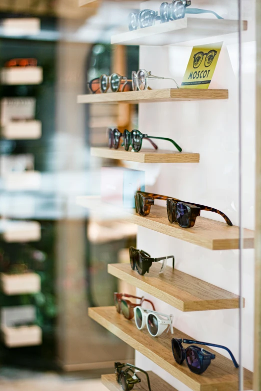 some shelves that have several pairs of sunglasses on them