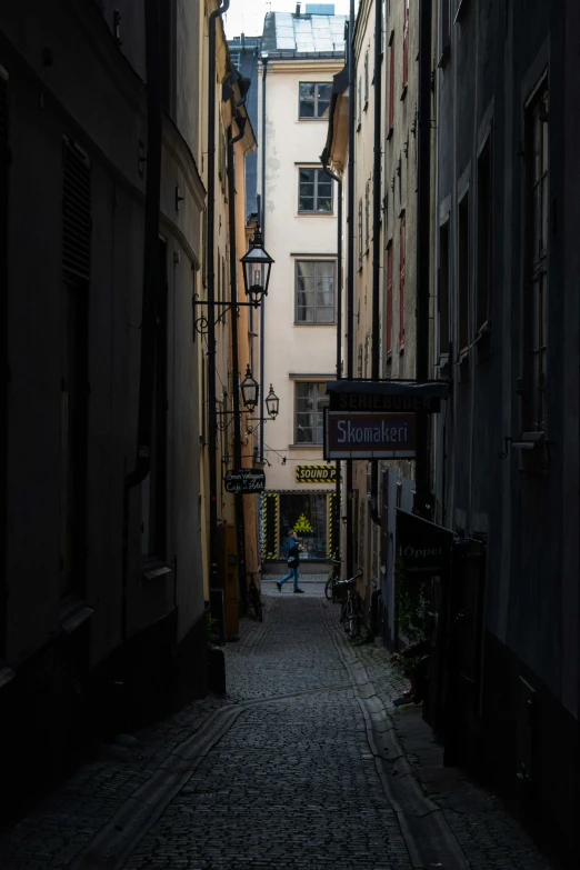 a street with a brick sidewalk and a sign