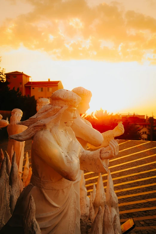 some statues and buildings in the background