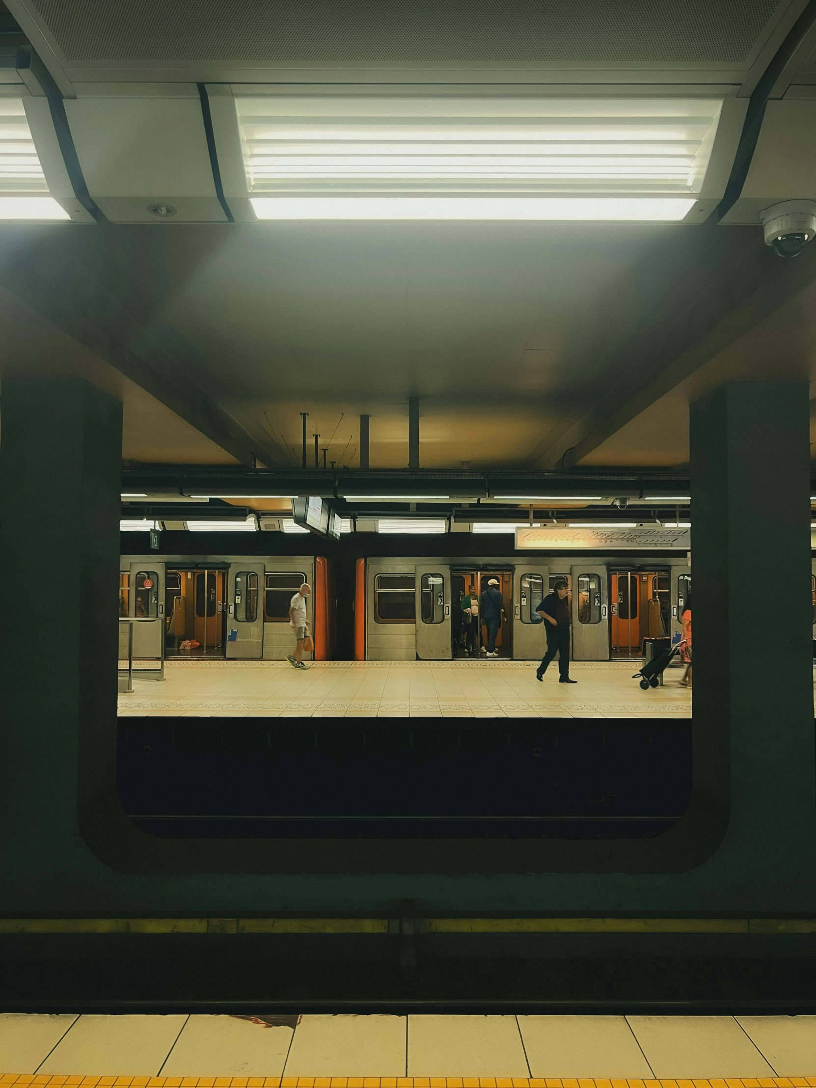 a very big empty train station with some people