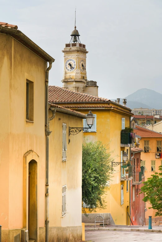 yellow buildings have a clock on each of the tower