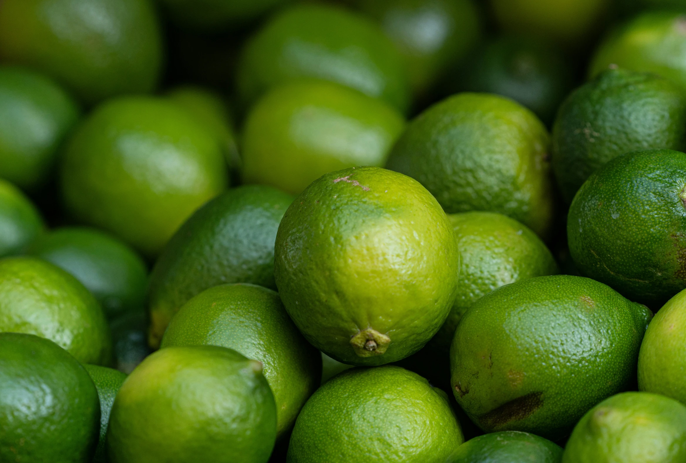 a pile of limes sitting on top of each other