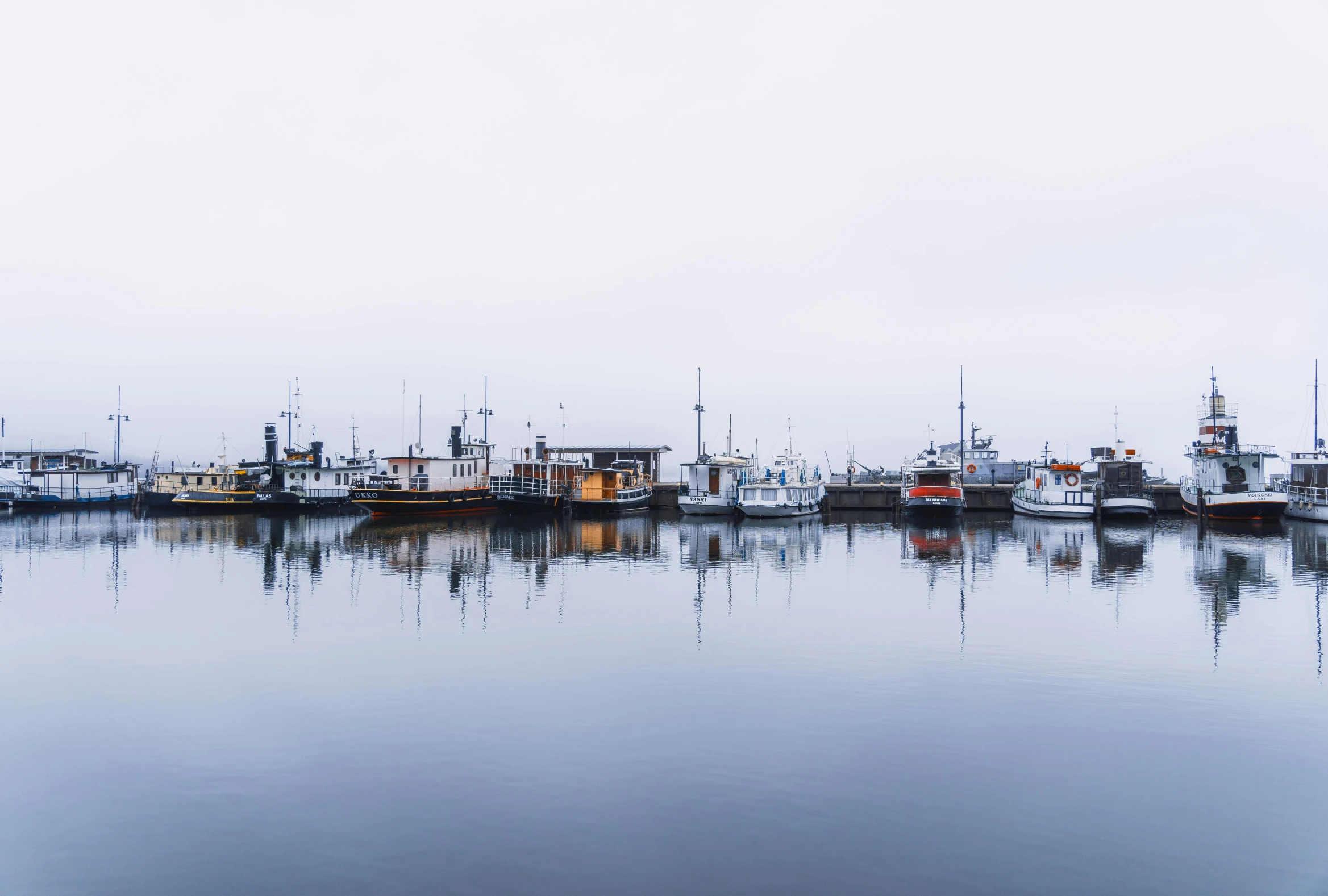 boats in a harbor on a hazy day