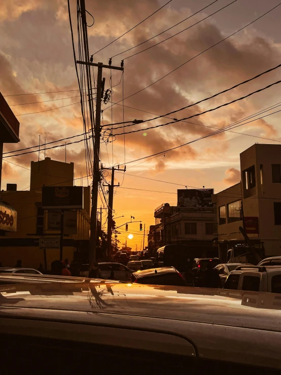 view of city street at sunset with telephone wires overhead