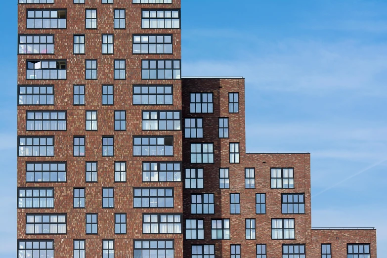 a building with lots of windows in front of a blue sky