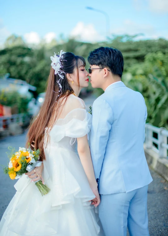 a bride and groom pose together outside for a picture