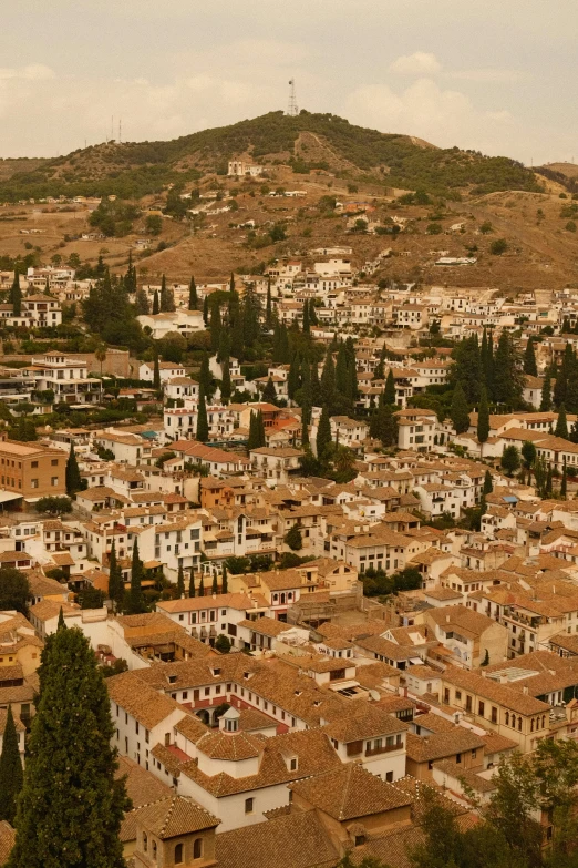 an old city with the surrounding hills and trees