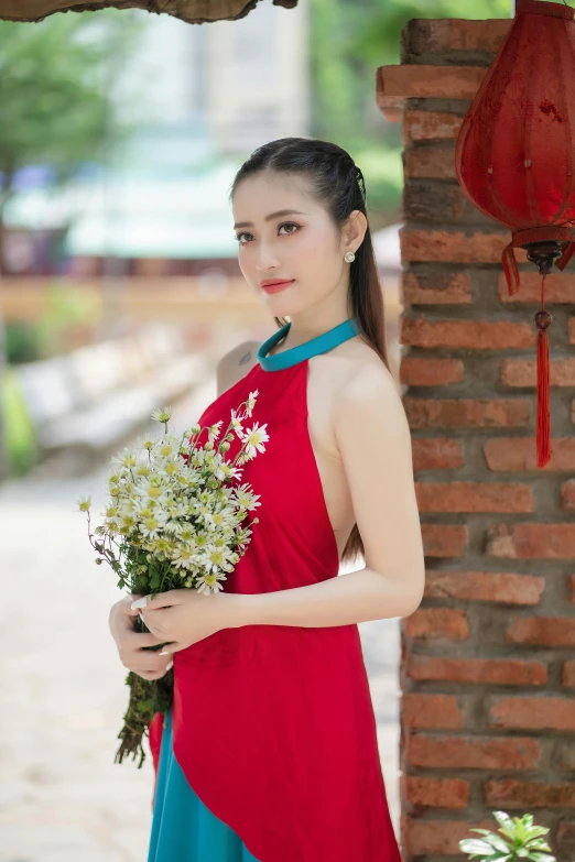 a woman holding flowers and posing for the camera