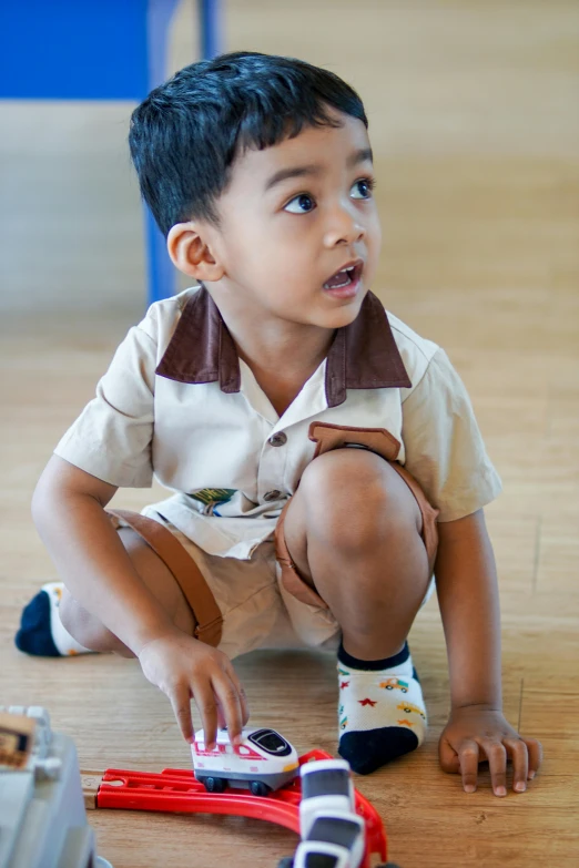 the child is playing with toys on the floor