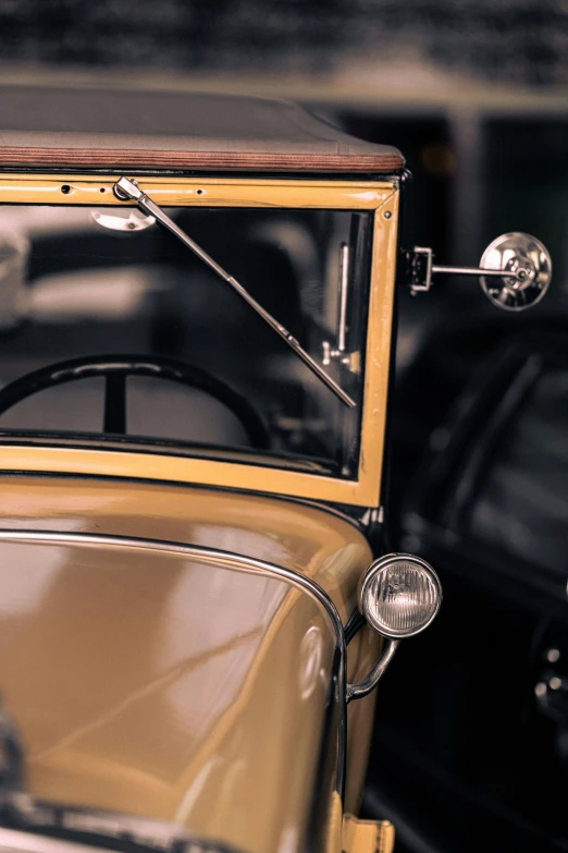 an old timey car sits parked in a garage