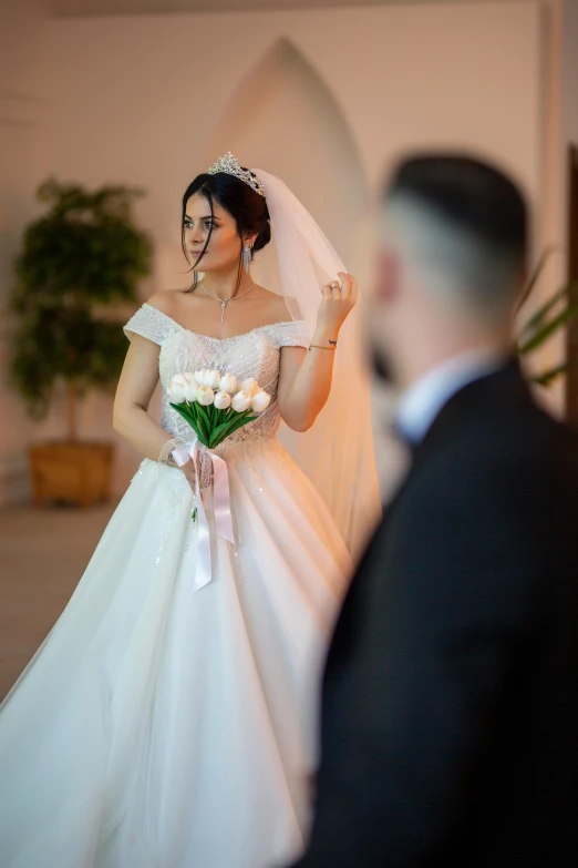 a man and woman walk down the aisle as a bride wears a veil